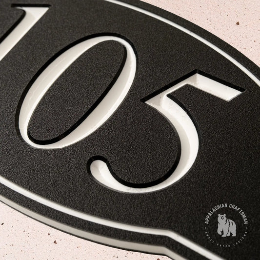 Close up of a black and white HDPE carved sign